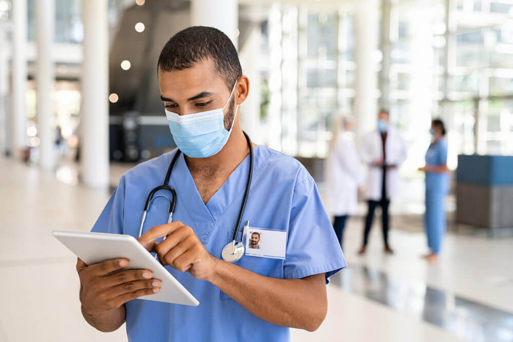 Male Nurse Working on Tablet