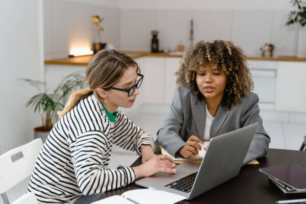 Two women staffing consultants working together looking at a computer screen