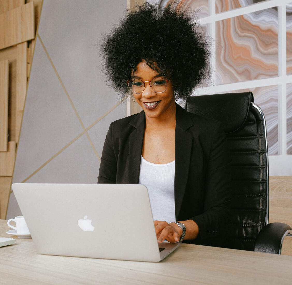 Staffing consultant looking at her computer smiling