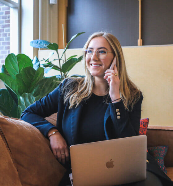 Woman smiling talking on the phone in the office - government staffing services