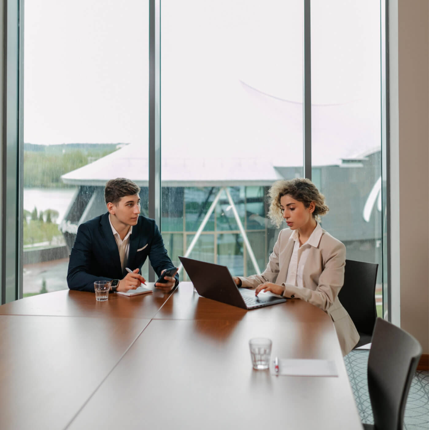 Two employees of IDR staffing firm meeting at an office table having a meeting