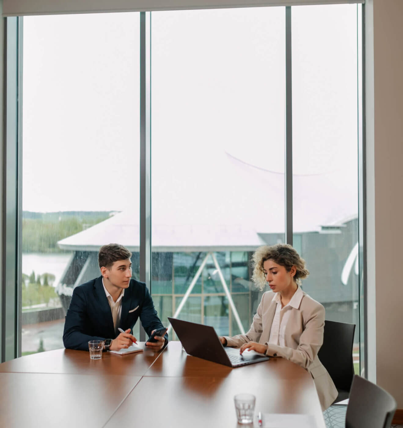 Two employees of IDR staffing firm meeting at an office table