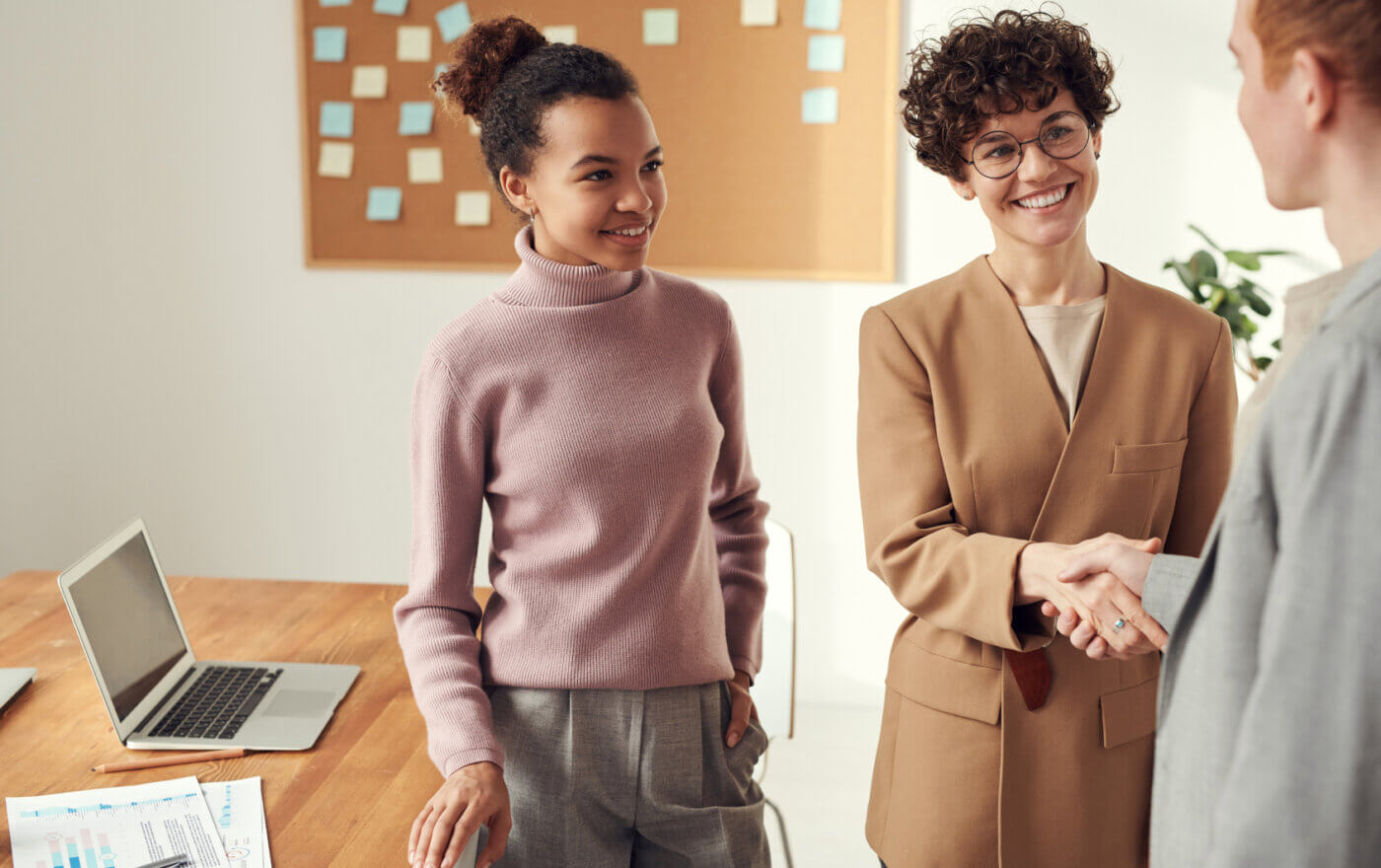 IDR staffing services employees shaking hands during a meeting